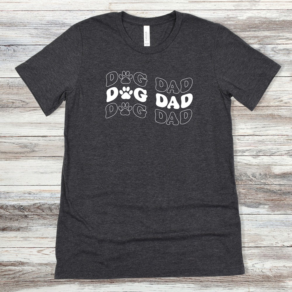 
                      
                        Text reading "Dog Dad" on a Dark Grey Heather Tee
                      
                    