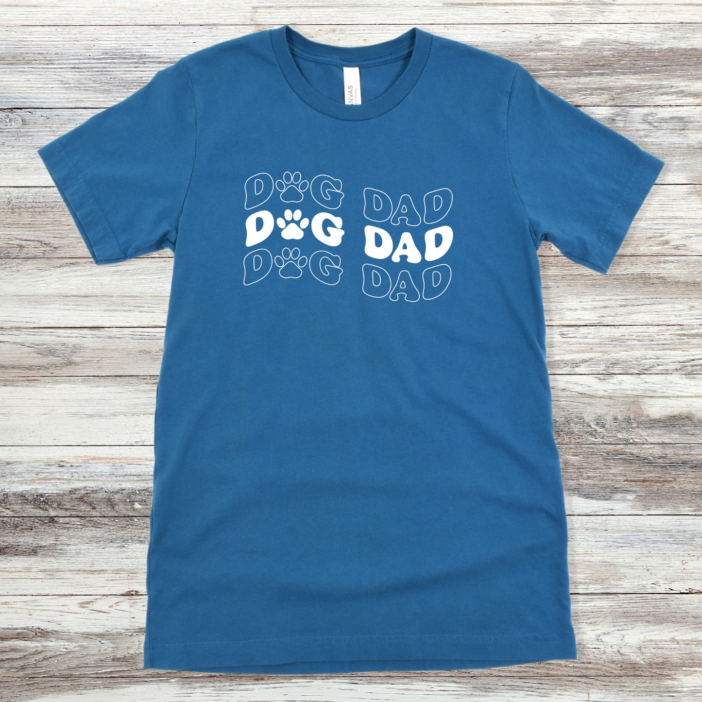 Text reading "Dog Dad" on a Deep Teal Tee