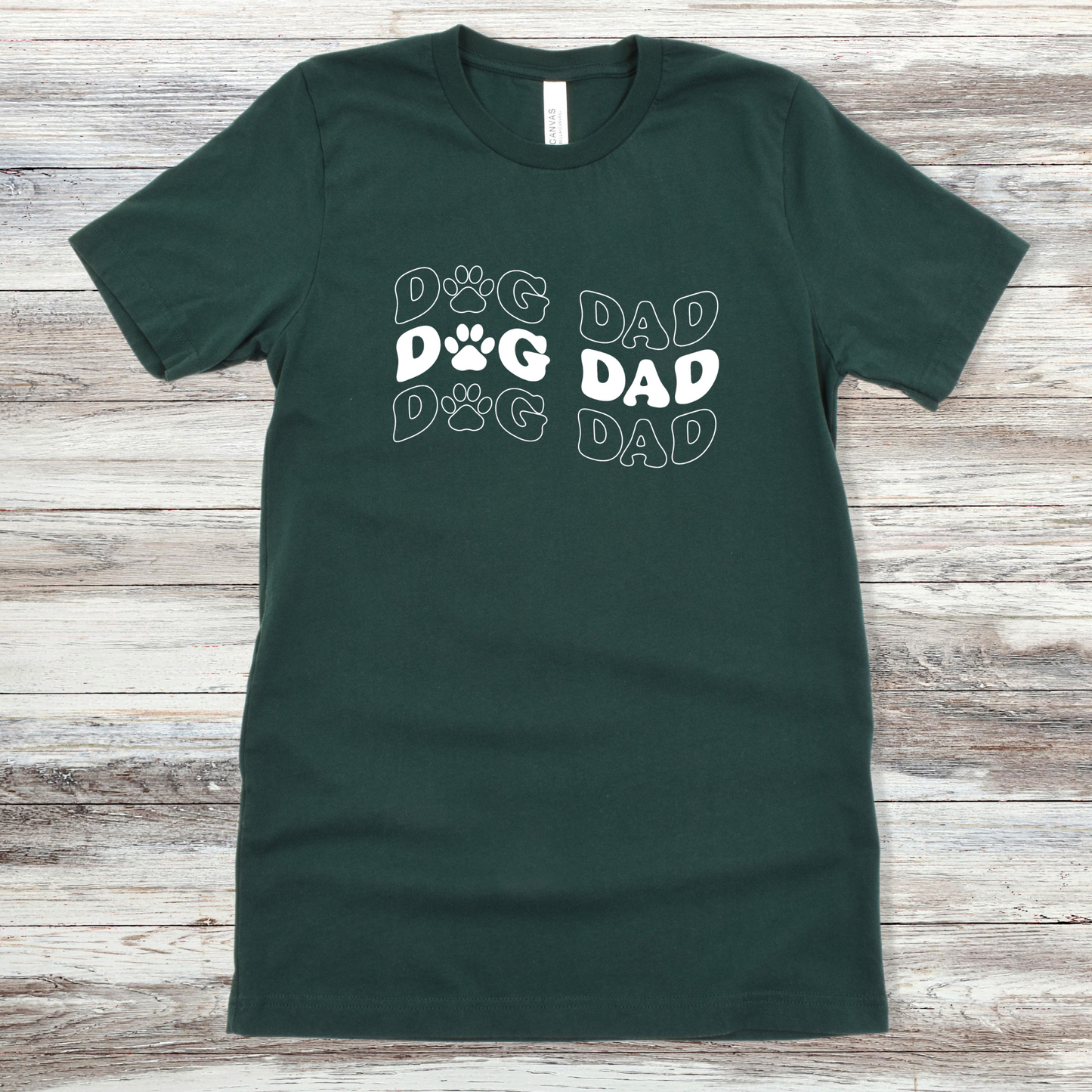 Text reading "Dog Dad" on a Forest Tee