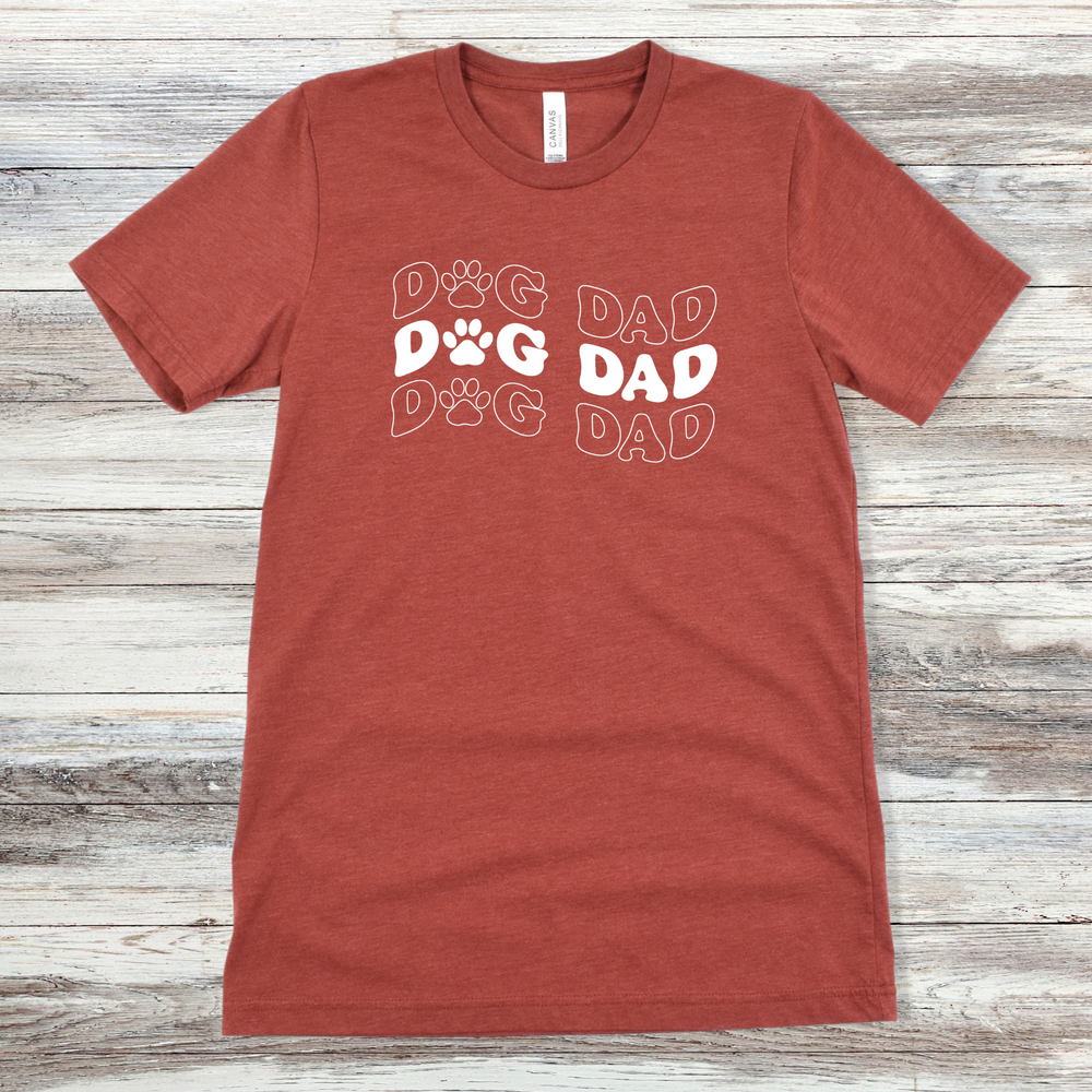 
                      
                        Text reading "Dog Dad" on a Heather Clay Tee
                      
                    