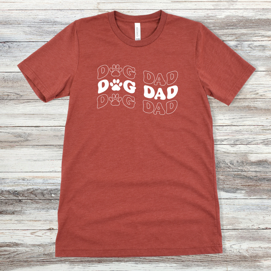 Text reading "Dog Dad" on a Heather Clay Tee