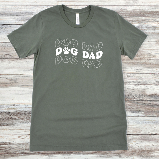 Text reading "Dog Dad" on a Military Green Tee